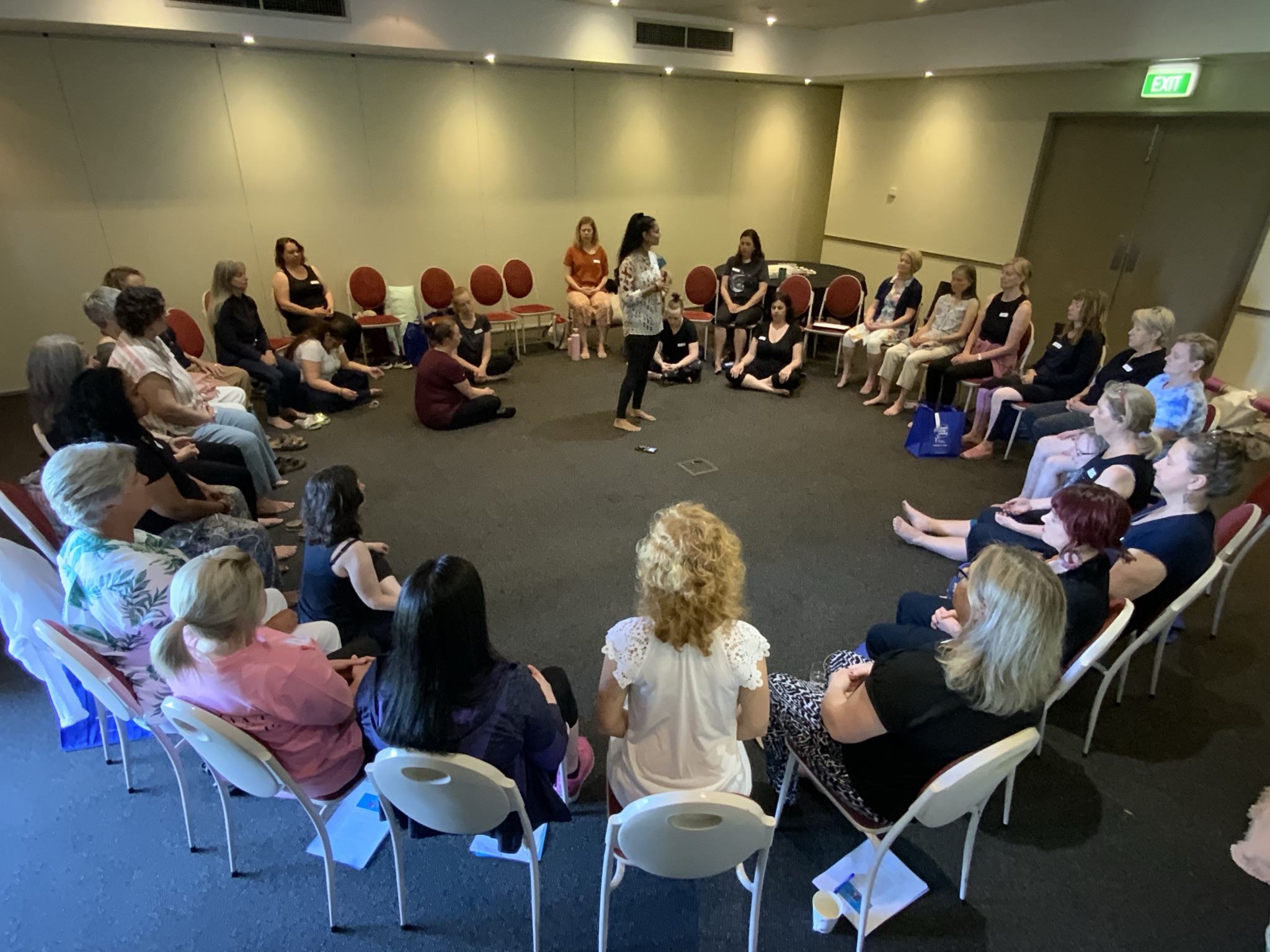 Usha leading a meditation at a retreat